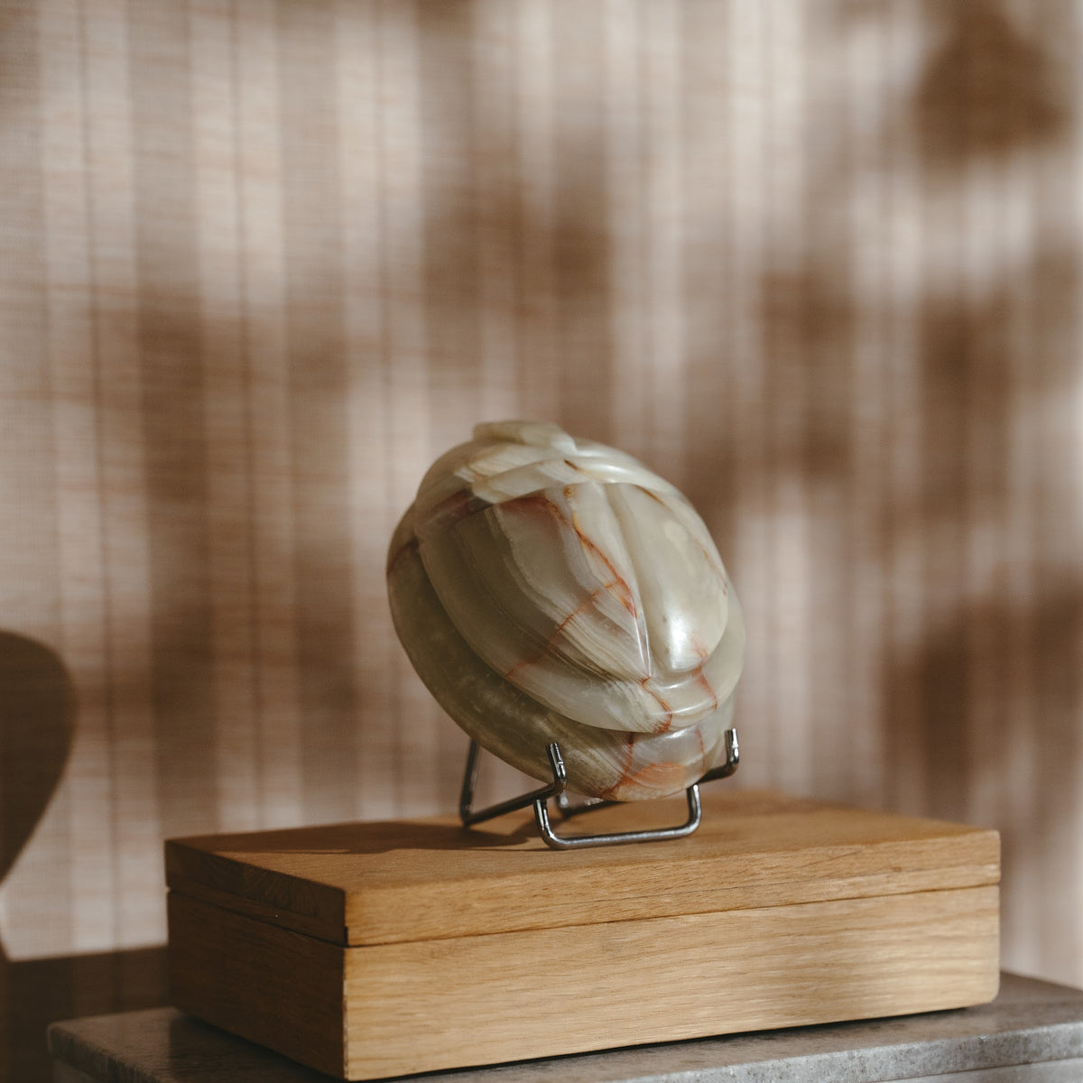 Scarab keepsake urn in jade green onyx resting on an oak Tray urn