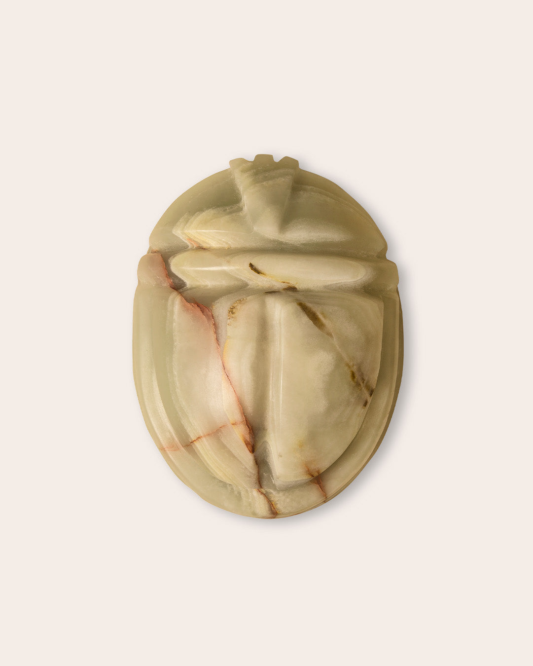 Scarab keepsake urn in jade green onyx, top view on a light background