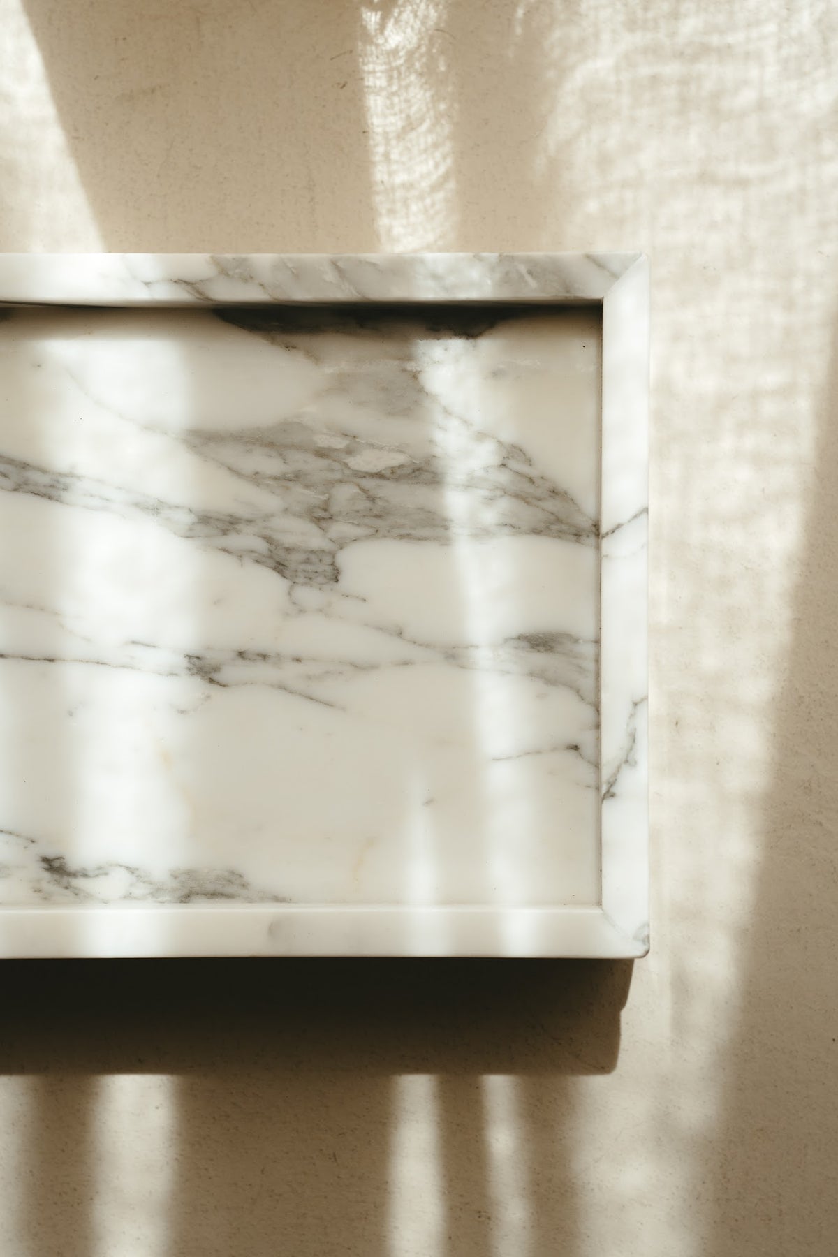 Arabescato marble Tray urn in soft daylight, showing the natural veining
