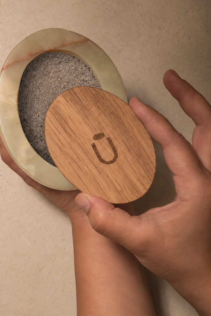 Scarab keepsake urn holding a small portion of ashes, engraved oak lid in hand