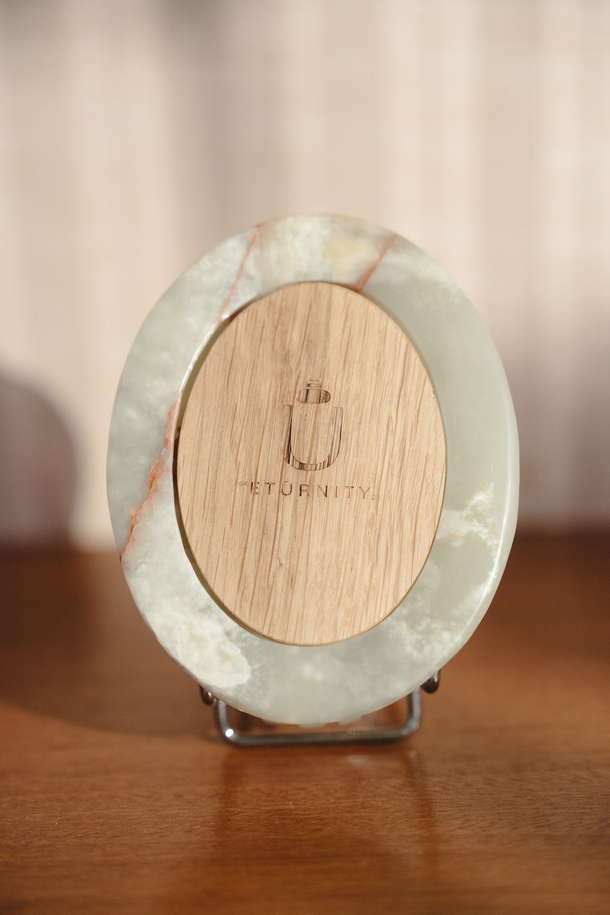 Back of the Scarab keepsake urn on a stand, showing the engraved oak lid
